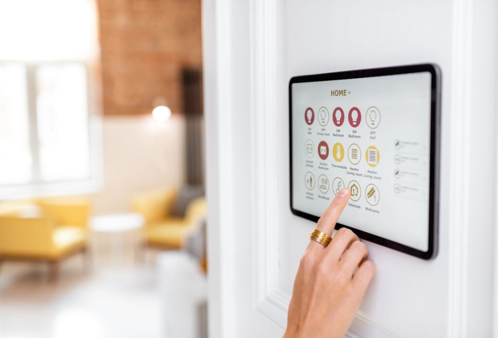 Personne utilisant un panneau de contrôle de sécurité intelligent dans un espace professionnel moderne.